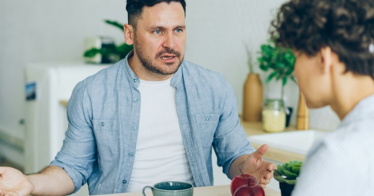 Two people talking calmly at the kitchen table